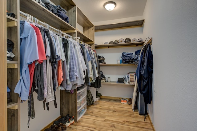 spacious closet with light hardwood / wood-style floors