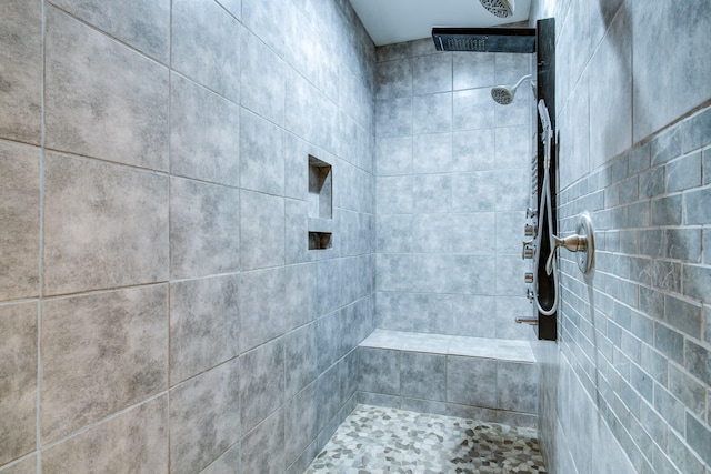 bathroom with a tile shower