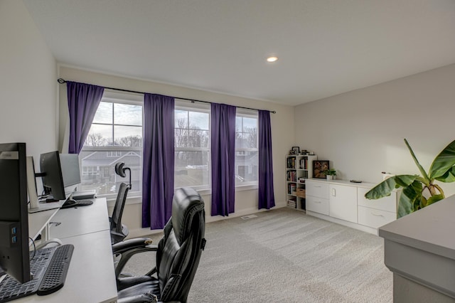 office space with a wealth of natural light and light colored carpet