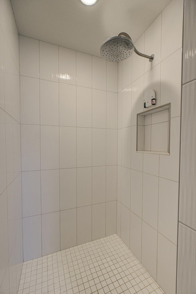 bathroom with tiled shower