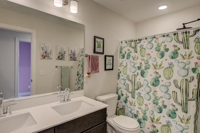 bathroom with vanity, curtained shower, and toilet