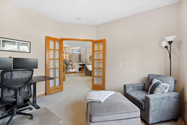 office with french doors, light carpet, and baseboards