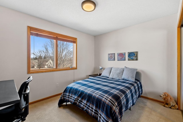 carpeted bedroom with baseboards and a textured ceiling