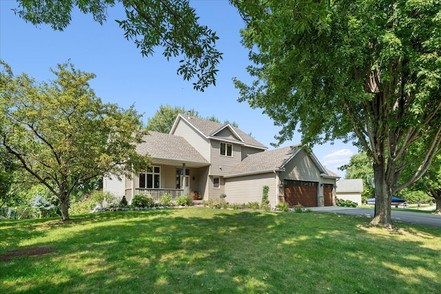 view of front of property with a shingled roof, a front lawn, aphalt driveway, a porch, and a garage