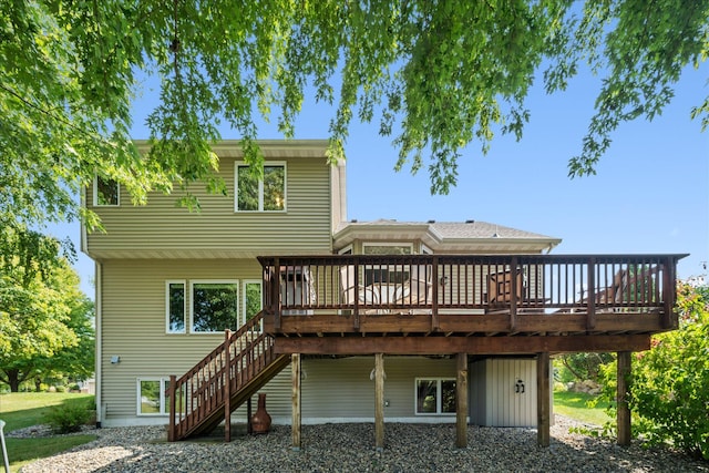 rear view of property featuring stairway and a wooden deck