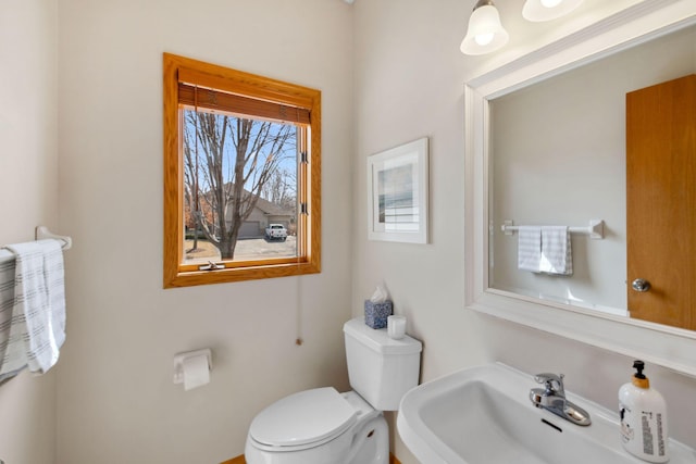 half bathroom with a sink and toilet