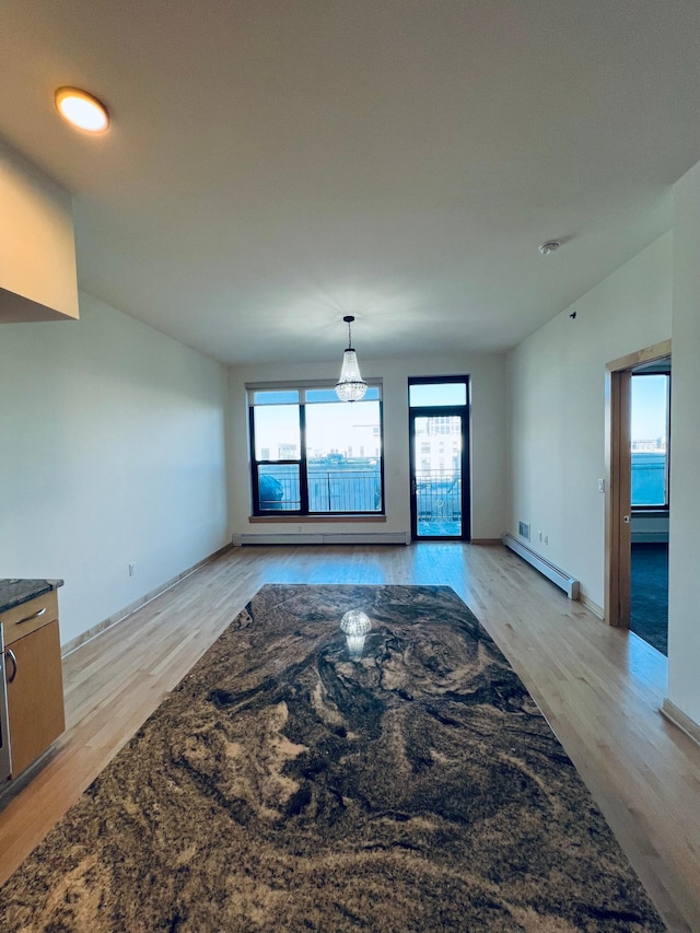 living room featuring light hardwood / wood-style floors and a baseboard heating unit