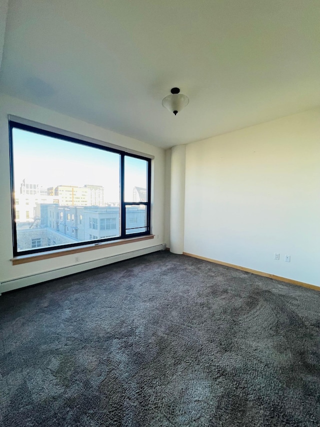 carpeted empty room with baseboard heating