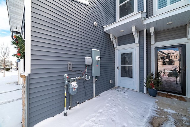 view of snow covered property entrance