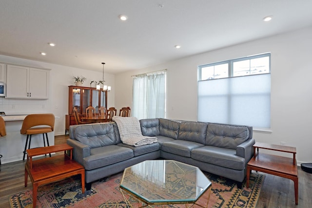 living room with hardwood / wood-style flooring and an inviting chandelier