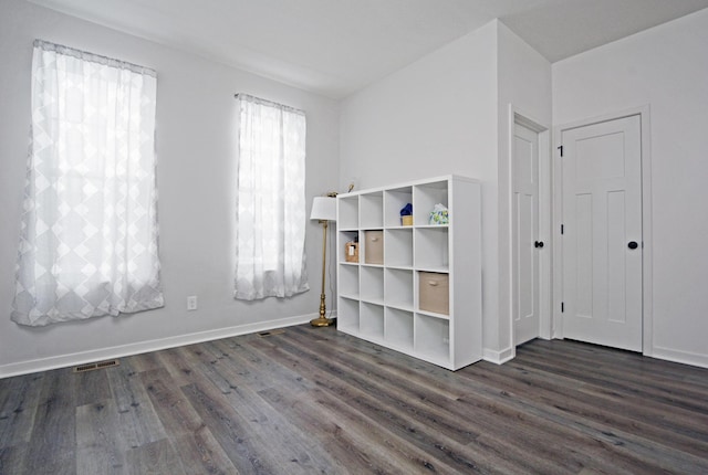 unfurnished bedroom featuring dark hardwood / wood-style flooring