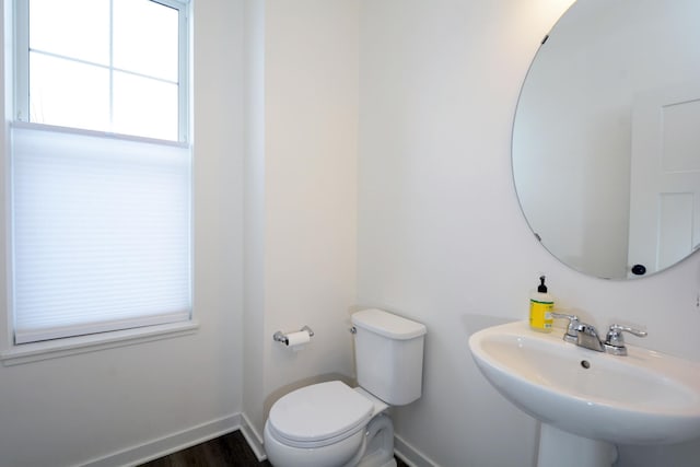 bathroom featuring toilet, hardwood / wood-style flooring, and sink