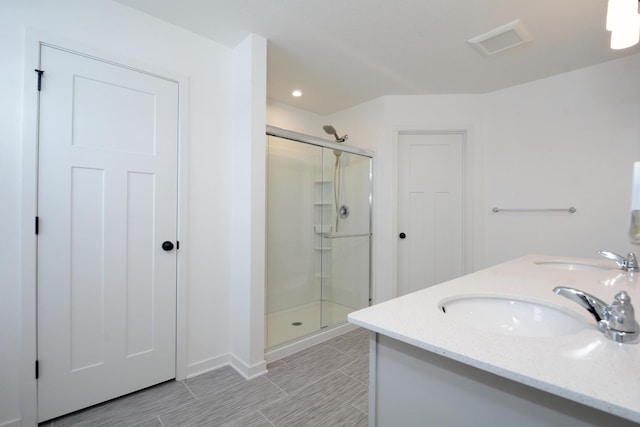 bathroom with an enclosed shower and vanity