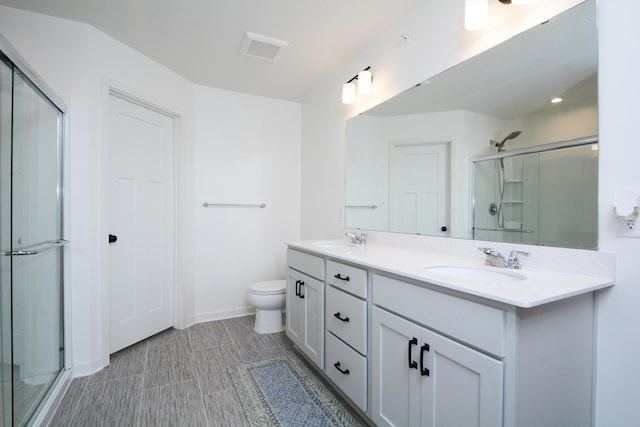 bathroom featuring vanity, toilet, and walk in shower