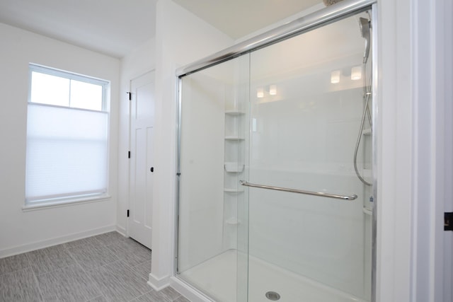 bathroom with a shower with door