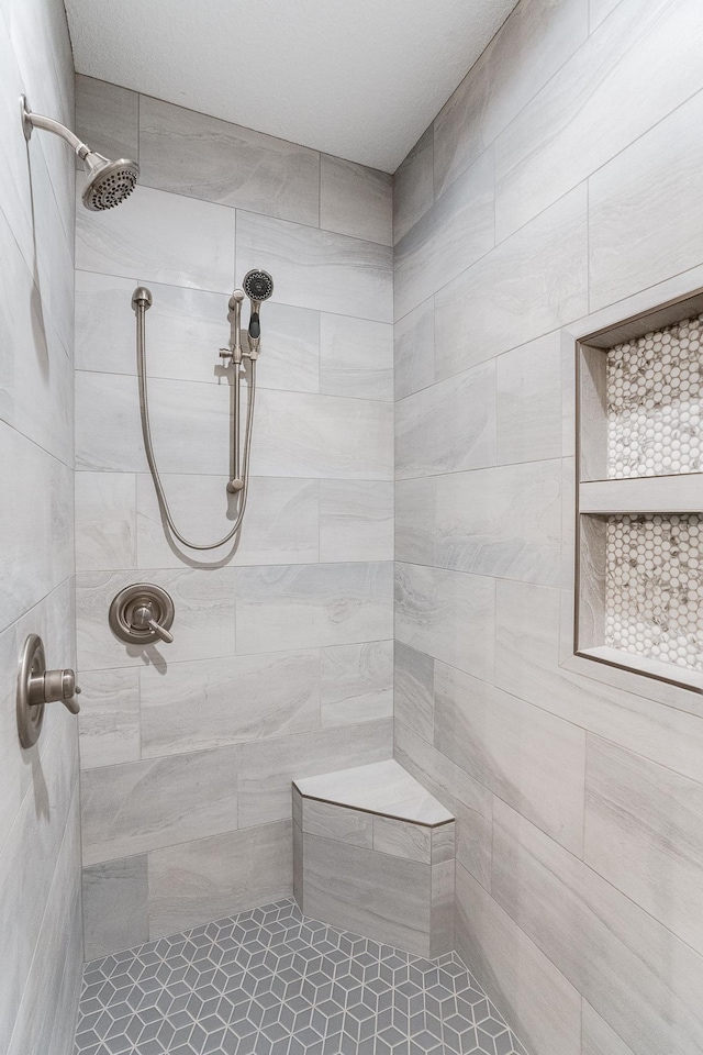 bathroom with a tile shower