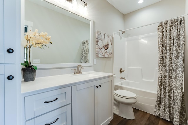 full bathroom featuring toilet, vanity, wood-type flooring, and shower / bath combination with curtain