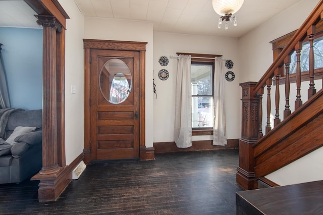 entrance foyer featuring dark hardwood / wood-style flooring and a chandelier