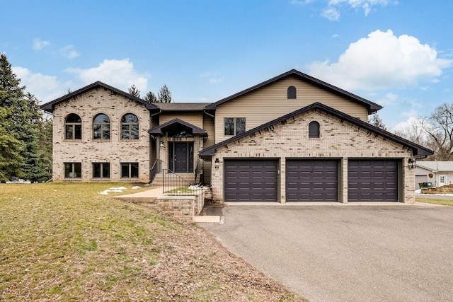 view of front of home featuring a garage and a front lawn