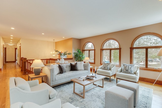 living room featuring an inviting chandelier and light hardwood / wood-style flooring