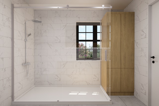 bathroom featuring tile patterned flooring and tiled shower