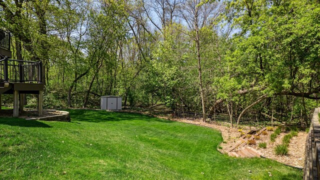 4167 Hallgren Ln, Excelsior, MN 55331 - view of green lawn featuring a storage shed, an outdoor structure, and a deck