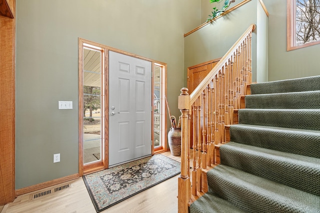 4167 Hallgren Ln, Excelsior, MN 55331 - entryway with wood finished floors, stairway, baseboards, and a high ceiling