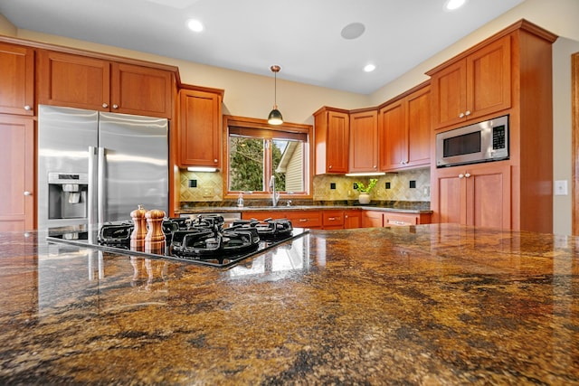 4167 Hallgren Ln, Excelsior, MN 55331 - kitchen with appliances with stainless steel finishes, decorative backsplash, a sink, recessed lighting, and hanging light fixtures