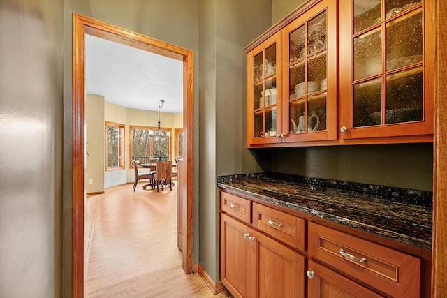 4167 Hallgren Ln, Excelsior, MN 55331 - bar with light wood-type flooring, baseboards, and a chandelier