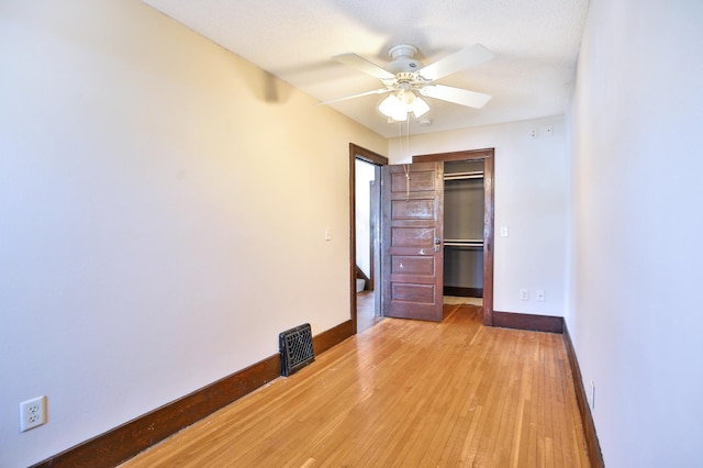 unfurnished bedroom with light wood-style floors, visible vents, baseboards, and a closet