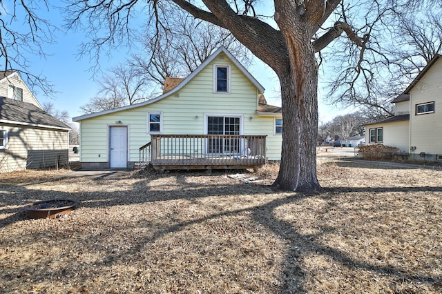 back of house with a deck