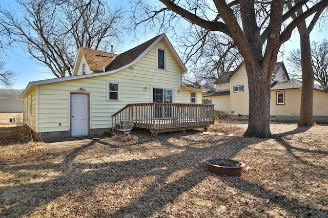 rear view of property featuring a deck