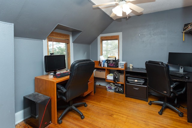 office with a ceiling fan, vaulted ceiling, plenty of natural light, and light wood-style floors