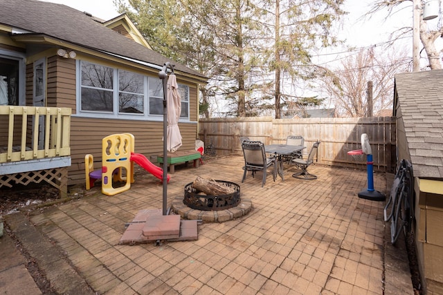 view of patio with a fenced backyard, outdoor dining space, and an outdoor fire pit