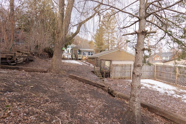 view of yard featuring a garage and fence