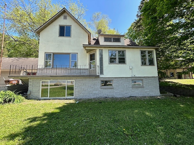 rear view of house featuring a yard