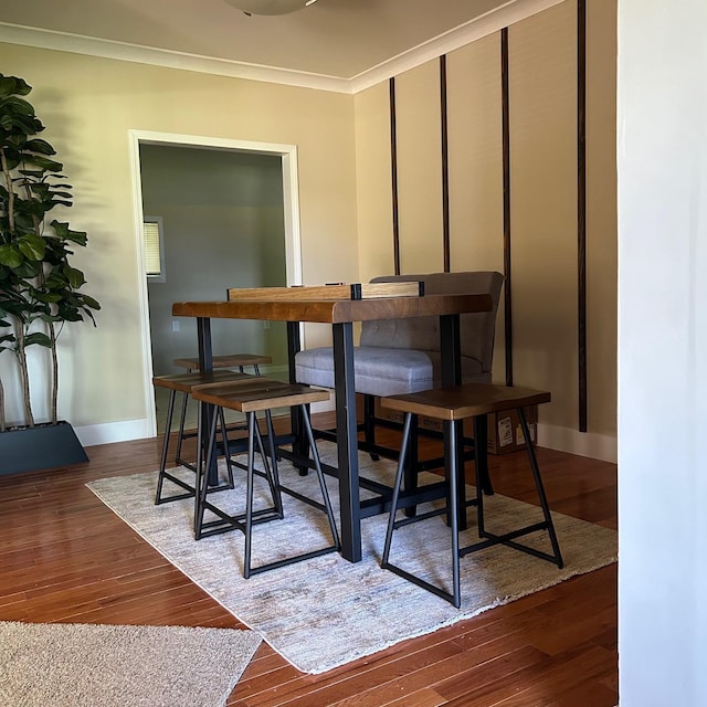 dining space featuring crown molding and dark hardwood / wood-style floors