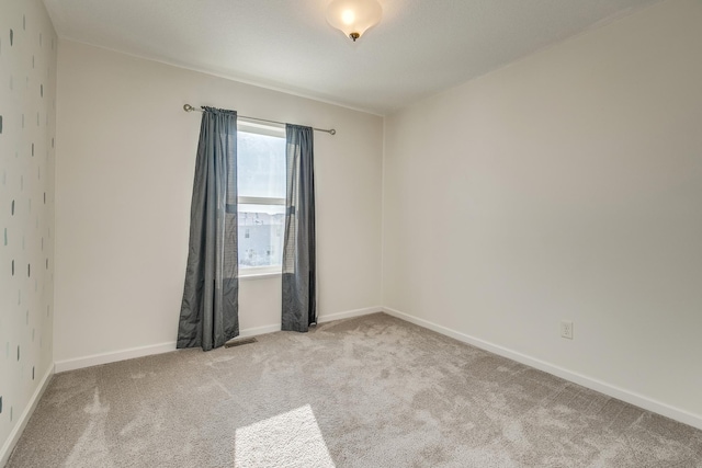 unfurnished room with light carpet