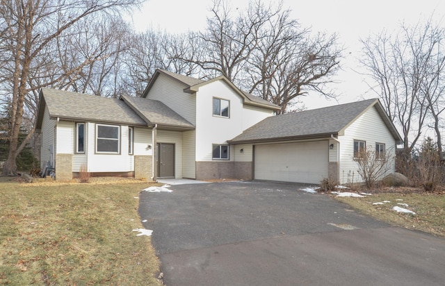 view of front facade with a front yard and a garage