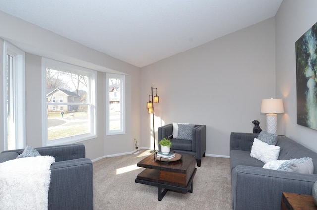 carpeted living room with vaulted ceiling