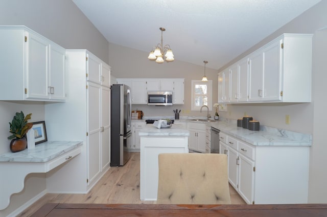 kitchen with white cabinetry, sink, pendant lighting, and appliances with stainless steel finishes