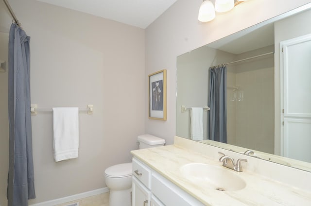 bathroom with tile patterned flooring, vanity, toilet, and walk in shower