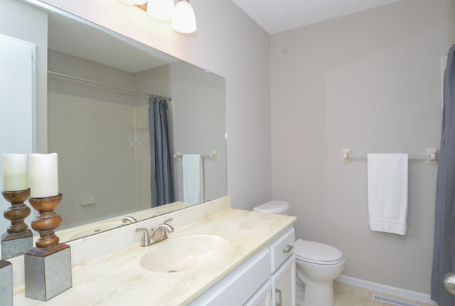 bathroom featuring vanity, toilet, and walk in shower