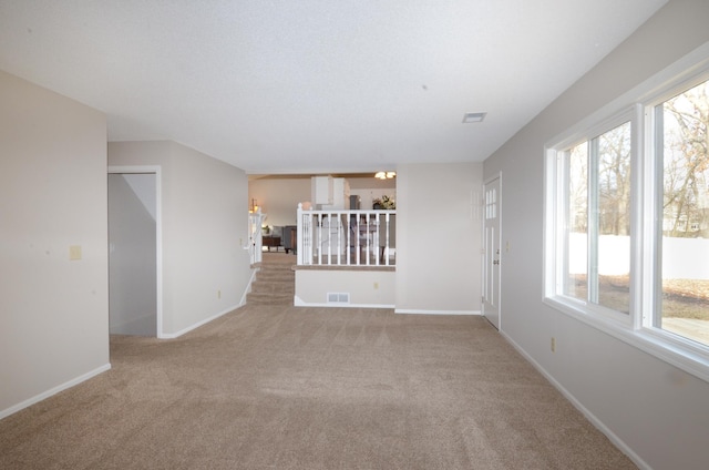 unfurnished living room featuring light carpet