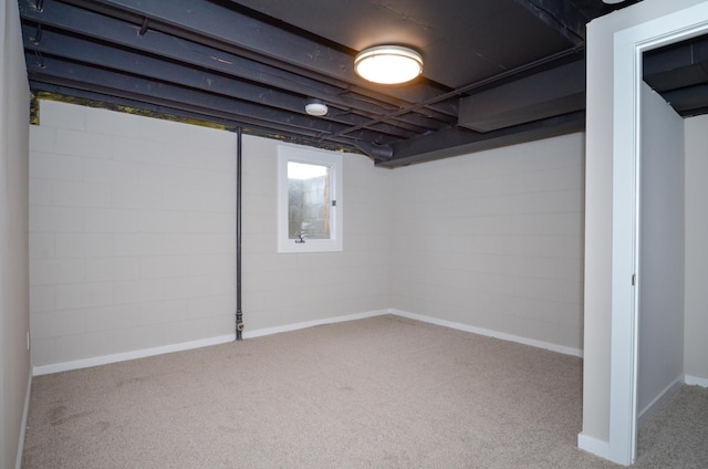 basement featuring light carpet