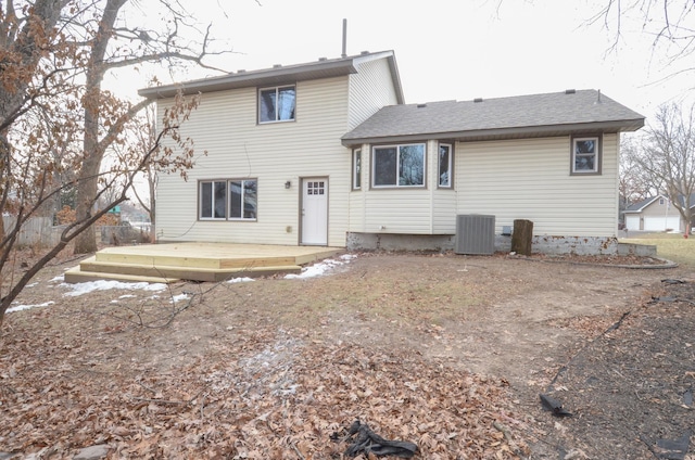 rear view of property with cooling unit and a wooden deck