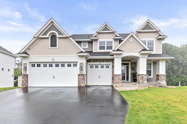 craftsman-style house with a front yard and a garage