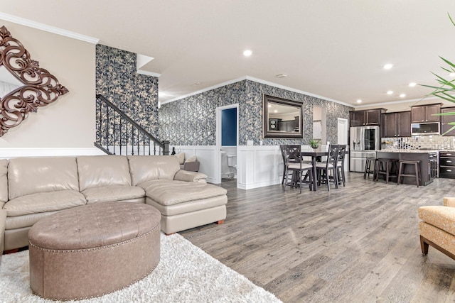 living room featuring hardwood / wood-style flooring and crown molding