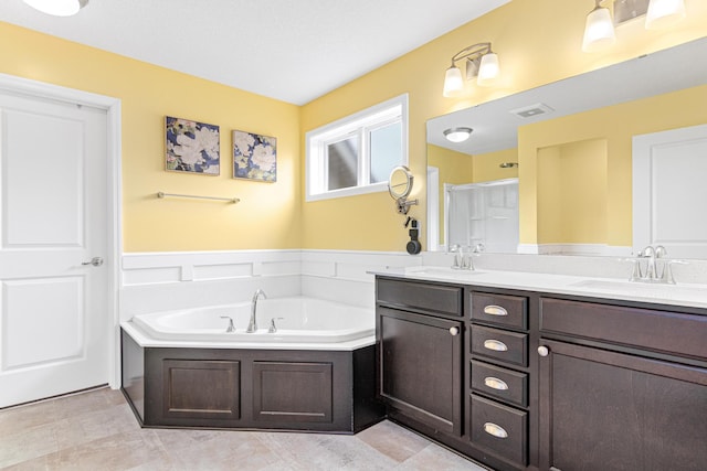 bathroom with vanity and independent shower and bath