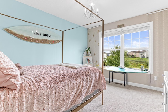 carpeted bedroom featuring a notable chandelier